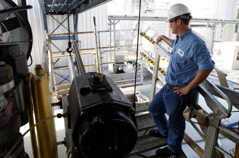 In this 2010 staff file photo, BASF employee Adam Cagle loads an international bound vessel with synthetic latex while at the Amnicola Highway plants in Chattanooga.