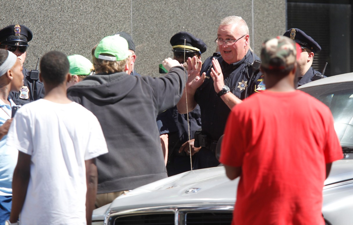 Staff photo by Doug Strickland.Police and Sheriff's officers speak with protesters who tried to follow members of the neo-Nazi National Socialist Movement group around the courts parking garage after the group held a rally Saturday, April 26, 2014, on the lawn of the Hamilton County Courthouse in Chattanooga, Tenn.