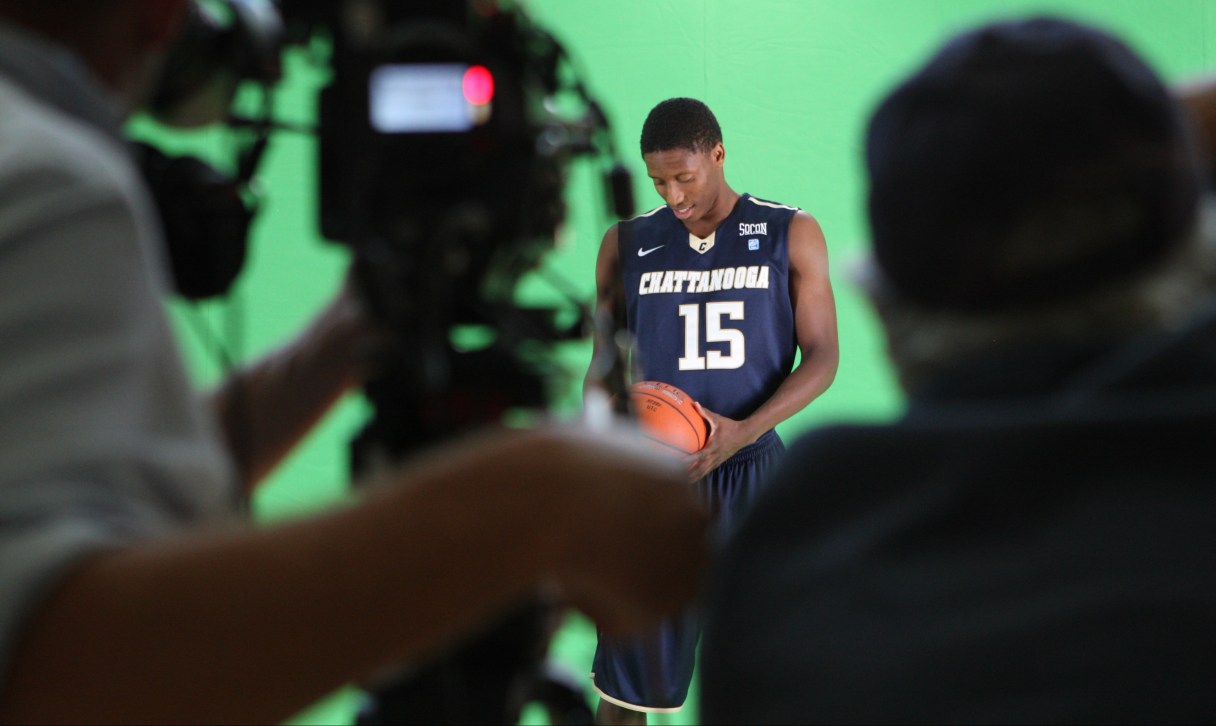 Eric Robertson looks down at the ball while getting his green screen video clips and photos taken at the Chattem Basketball Practice Facility on Wednesday. Atomic Films' Dave Lang, left, was shooting video, while Med Dement, hired out by Lang, was shooting still photographs.