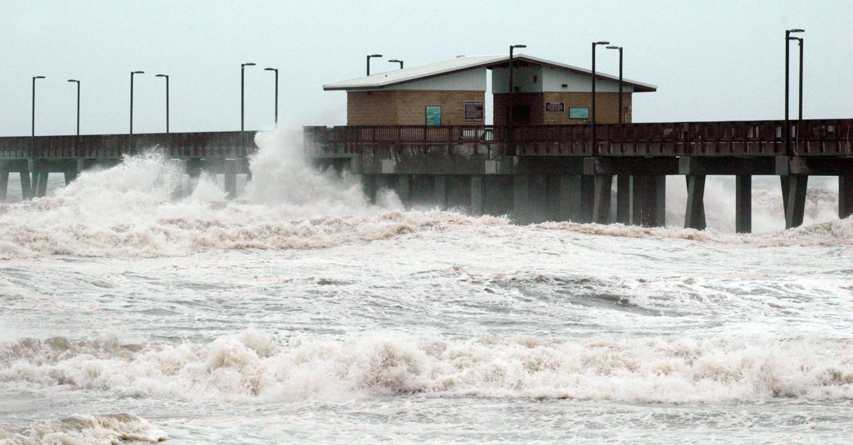 Waves crash into the public fishing pier at Gulf State Park in Gulf Shores, Ala., shortly before Hurricane Isaac made landfall in Louisiana on Tuesday, Aug. 28, 2012. Crews removed flooring panels from the pier to prevent damage. (AP Photo/Jay Reeves)