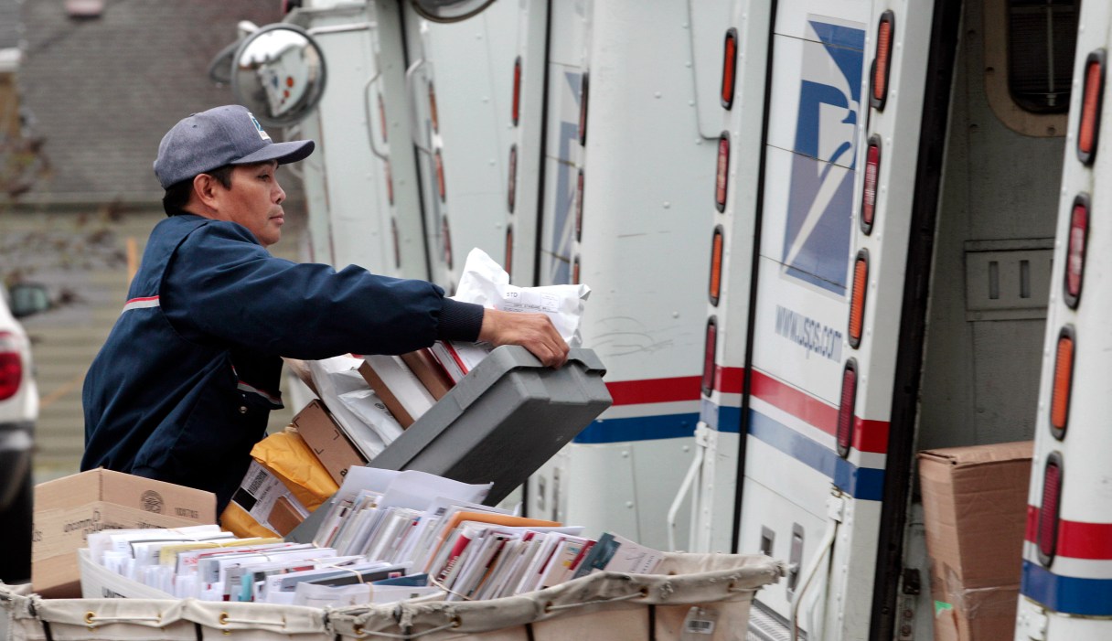 Letter carrier Diosdado Gabnat moves boxes of mail into his truck to begin delivery at a post office in Seattle. Americans for generations have come to depend on door-to-door mail delivery. It's about as American as apple pie. But with the Postal Service facing billions of dollars in annual losses, the long-cherished delivery service could be virtually phased-out by 2022 under a proposal a House panel was considering Wednesday. Curbside delivery, which includes deliveries to mailboxes at the end of driveways, and cluster box delivery would replace letter carriers slipping mail into front-door boxes.