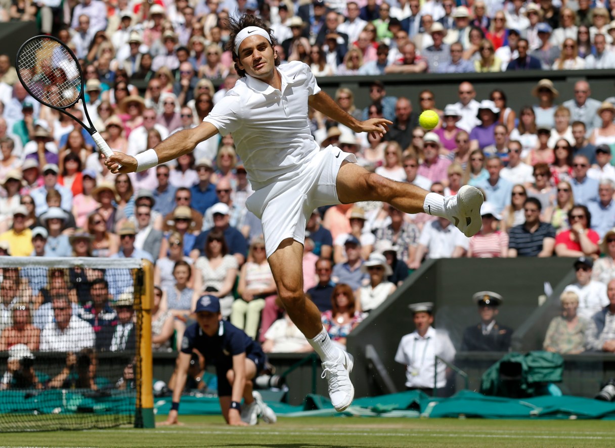 FILE - In this July 6, 2014, file photo, Roger Federer of Switzerland leaps in an attempt to play a return to Novak Djokovic of Serbia during their men's singles final match at the All England Lawn Tennis Championships in Wimbledon, London. Heading into the U.S. Open, Federer, Rafael Nadal, Novak Djokovic and Andy Murray have won 36 of the past 38 Grand Slam titles, a stretch dating to the 2005 French Open. Nowadays, there seems to be a growing sense _ or hope, maybe _ among the best of the rest on the men's tennis tour that the quartet might be more vulnerable than ever. (AP Photo/Sang Tan, Pool, File)