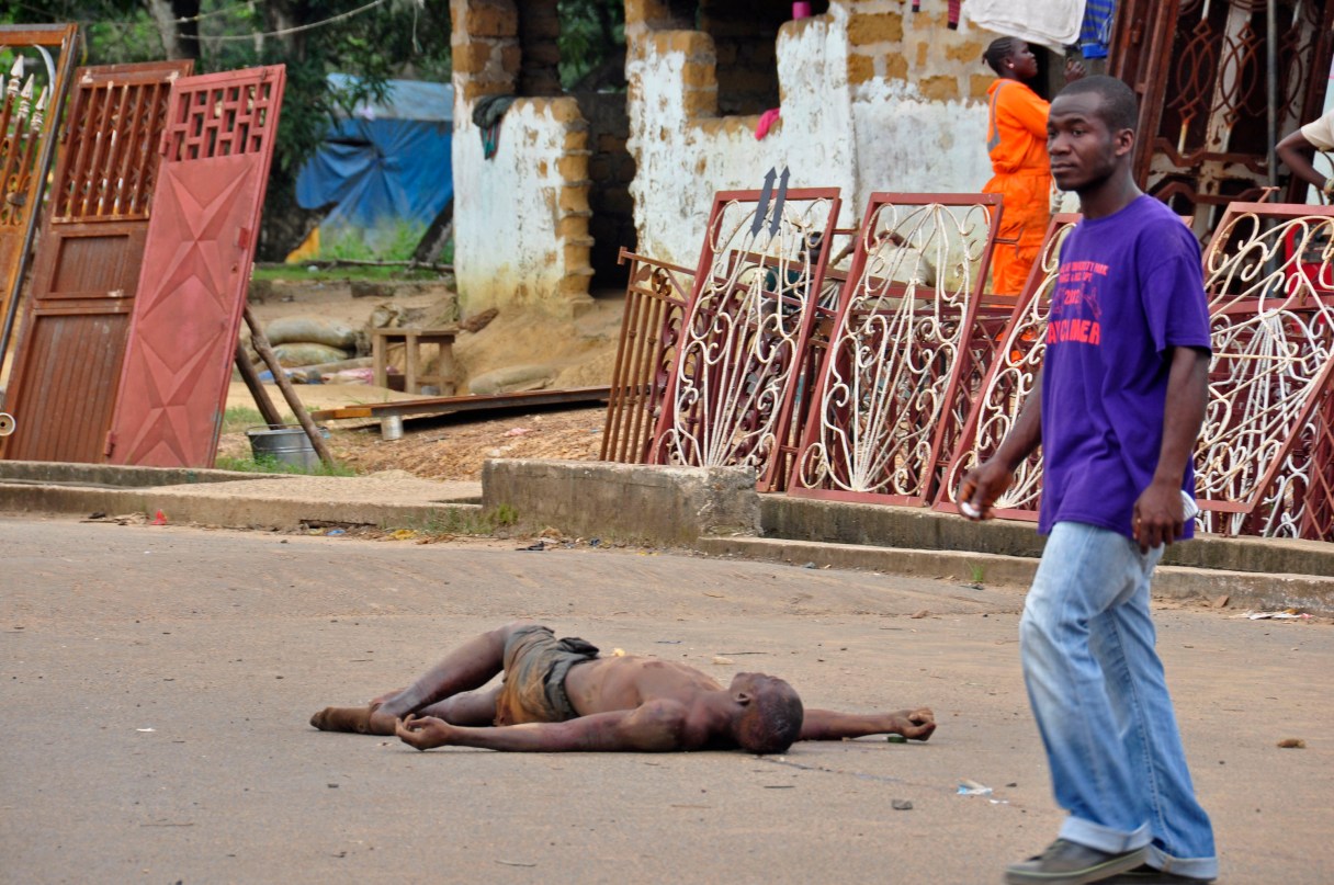 The lifeless body of a man lays unattended in the street as locals suspect him of dying from the deadly Ebola virus, as government warns the public not to leave Ebola victims in the streets in the city of Monrovia, Liberia, Tuesday, Aug. 5, 2014. A second American aid worker infected with Ebola arrived Tuesday in Atlanta, where doctors will closely monitor the effect of an experimental drug she agreed to take even though its safety was never tested on humans. Nancy Writebol arrived from Monrovia, Liberia, in a chartered plane at Dobbins Air Reserve Base and will join Dr. Kent Brantly in the isolation unit at Emory University Hospital, just downhill from the U.S. Centers for Disease Control and Prevention. (AP Photo/Abbas Dulleh)