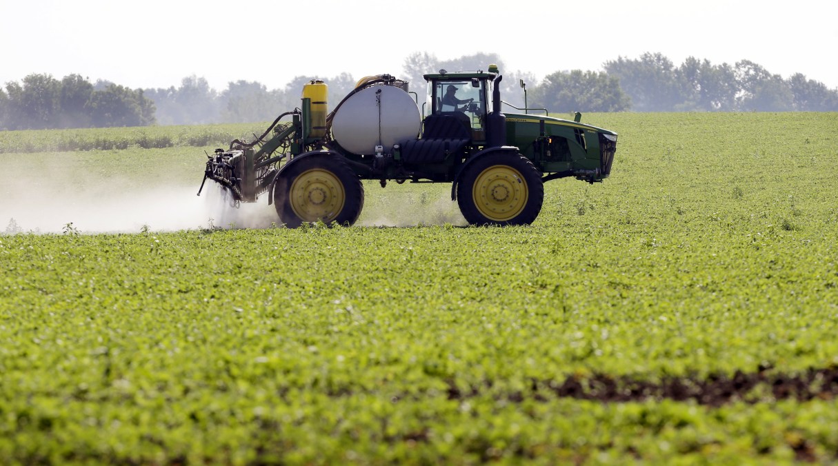 FILE - This July 11, 2013, file photo shows Blake Beckett of West Central Cooperative as he sprays a soybean field, in Granger, Iowa. Faced with tougher and more resistant weeds, corn and soybean farmers are anxiously awaiting government decisions on a new version of a popular herbicide _ and on genetically modified seeds to grow crops designed to resist it. The Environmental Protection Agency is expected to rule in the fall of 2014 on Dow AgroSciences’ application to market Enlist, a new version of the 2,4-D herbicide that’s been around since the 1940s.(AP Photo/Charlie Neibergall, File)