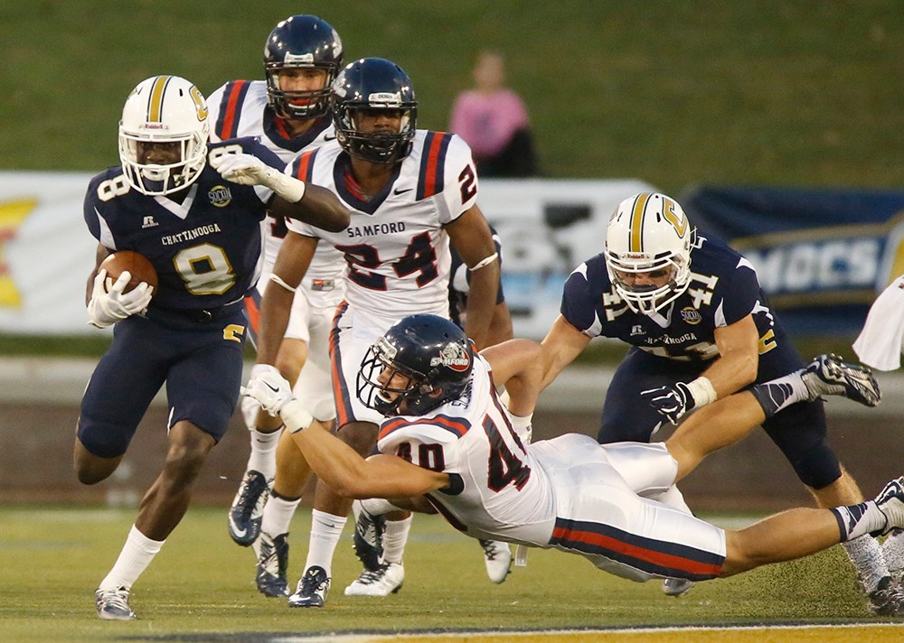 UTC wide receiver Tommy Hudson, left, breaks a tackle by Samford tight end Devon Schmitt to return a kickoff for a touchdown Saturday at Finley Stadium.
