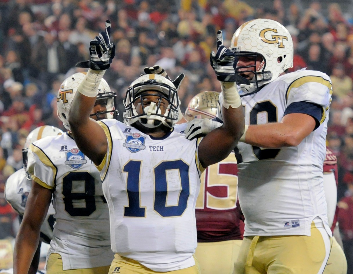 Georgia Tech running back Synjyn Days (10) celebrates his touchdown run against Florida State with offensive lineman Shaquille Mason, right, during the first half of the Atlantic Coast Conference championship NCAA college football game in Charlotte, N.C., Saturday, Dec. 6, 2014. (AP Photo/Mike McCarn)