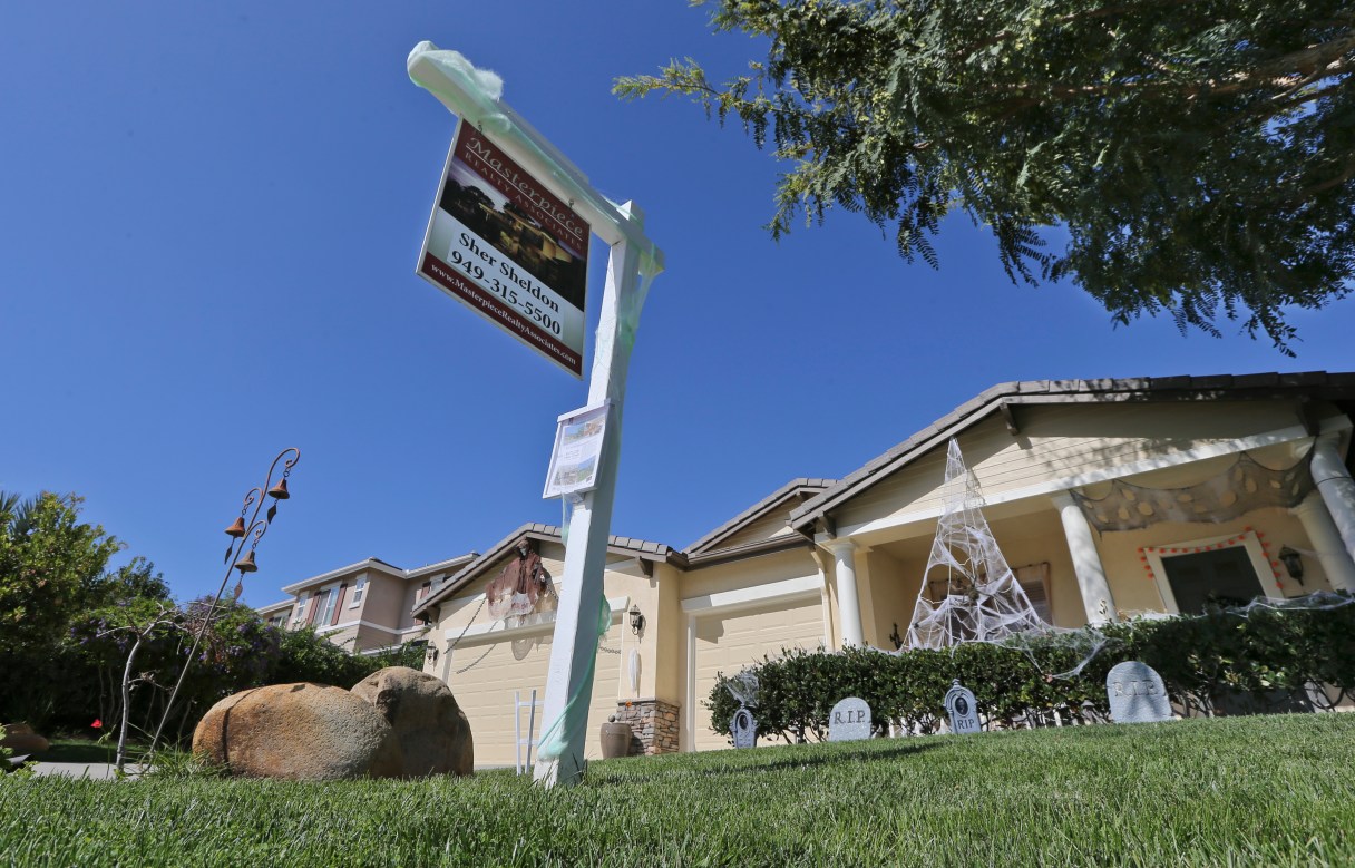 FILE - In this Oct. 27, 2014 file photo, a realty sign is posted in front of a home for sale in Carlsbad, Calif. Real estate data provider CoreLogic reports on October home prices on Tuesday, Dec. 2, 2014. (AP Photo/Lenny Ignelzi, File)