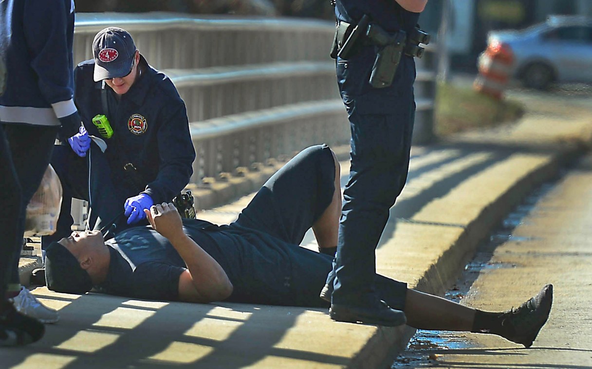 A Charlotte firefighter tends to Carolina Panthers NFL football quarterback Cam Newton following a two-vehicle crash not far from the team's stadium in Charlotte, N.C., Tuesday, Dec. 9, 2014. (AP Photo/The Charlotte Observer, Todd Sumlin) MAGS OUT; TV OUT; NEWSPAPER INTERNET ONLY