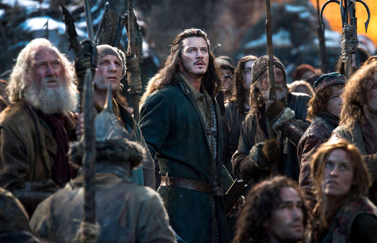 This photo provided by Warner Bros. Entertainment shows Luke Evans, center, as Bard in the fantasy adventure "The Hobbit: The Battle of the Five Armies," a production of New Line Cinema and Metro-Goldwyn-Mayer Pictures (MGM), releases by Warner Bros. Pictures and MGM. (AP Photo/Warner Bros. Entertainment Inc.- MGM, Mark Pokorny)