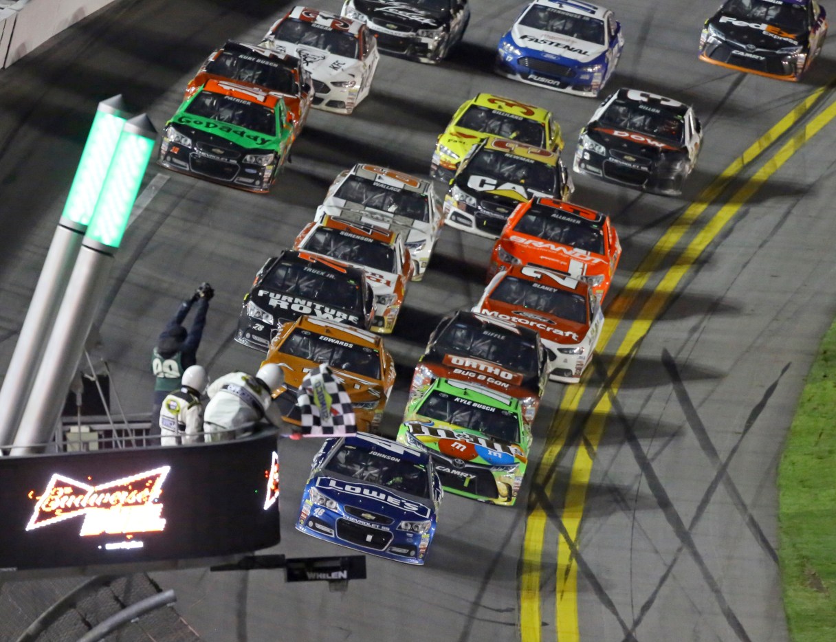 Jimmie Johnson, front, takes the checkered flag to win the second of two qualifying races for the Daytona 500 NASCAR Sprint Cup series auto race at Daytona International Speedway in Daytona Beach, Fla., Thursday, Feb. 19, 2015. (AP Photo/David Graham)