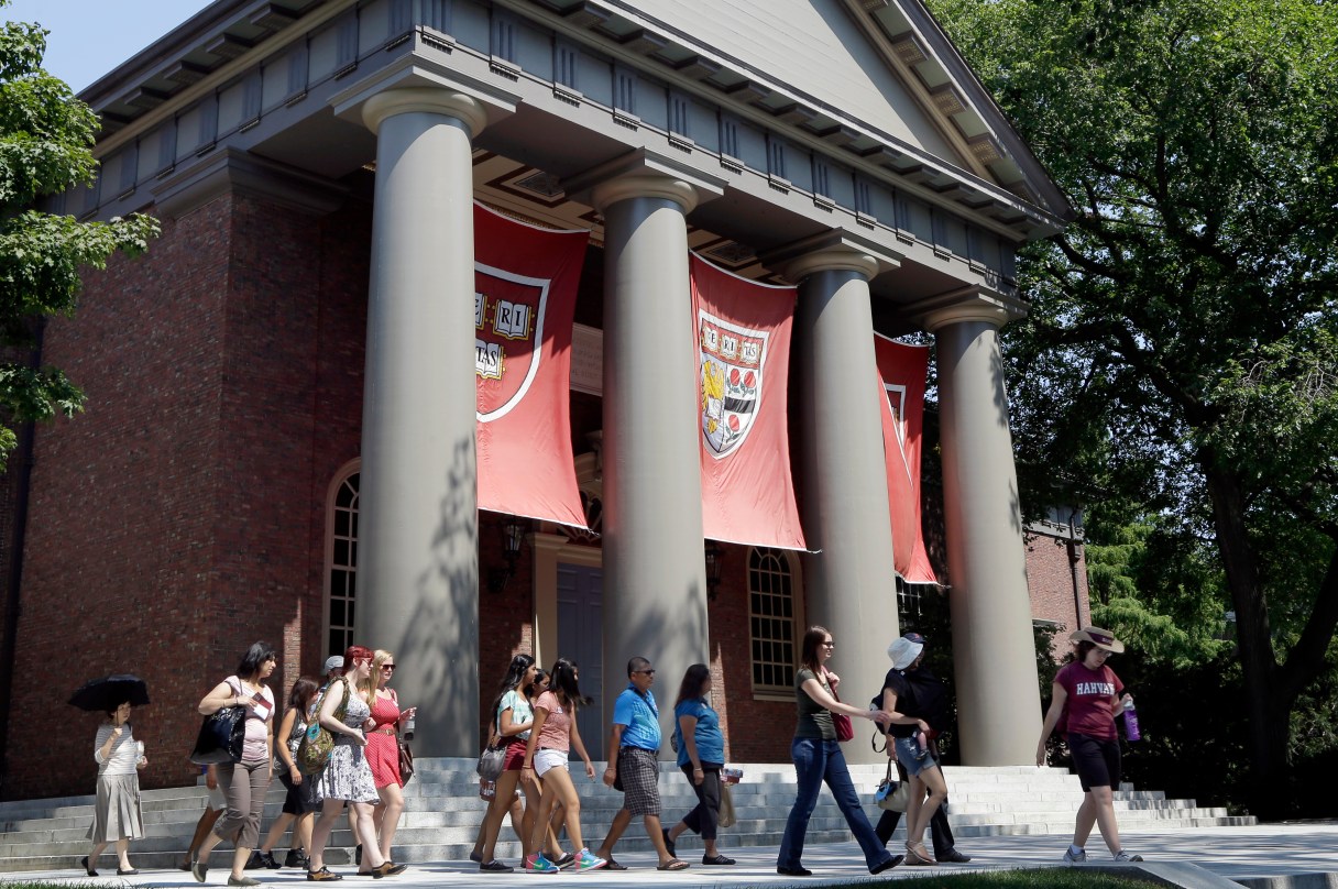 FILE - In this Aug. 30, 2012 file photo, people are led on a tour group at the campus of Harvard University in Cambridge, Mass. The Ivy League school is the alma mater for seven chief executives who led their companies’ IPOs in 2014. That’s more than twice the amount of the next-best schools, according to figures from Equilar, an executive compensation data firm. (AP Photo/Elise Amendola, File)