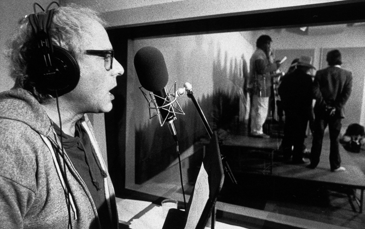 FILE - In this Nov. 20, 1987 file photo, then-Burlington, Vt. Mayor Bernie Sanders sings during a recording session in Burlington, Vt. Sanders, accompanied by a backup group of Vermont singers, background, was putting out a tape of five songs and a discussion of his philosophy that will be available in stores. Sanders feels music is a powerful way to communicate with the masses. Once a democratic socialist, always a democratic socialist. Once a scold of big money in politics, still a scold. No one can accuse Sanders of flip-flopping over his four decades in public life. Rock steady, he’s inhabited the same ideological corner from which he now takes on Hillary Rodham Clinton in an improbable quest for the Democratic presidential nomination. (AP Photo/Toby Talbot, File)