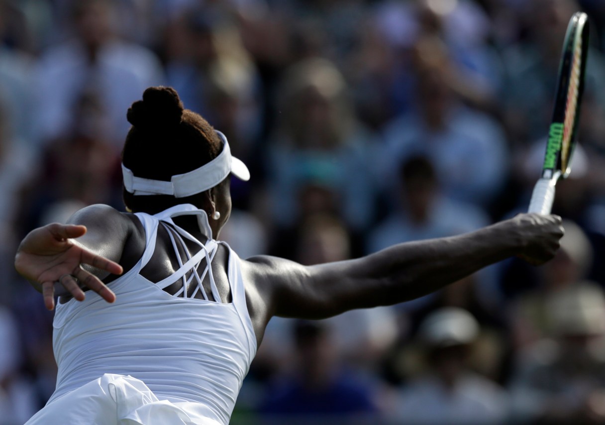 Venus Williams of the United States returns a ball to Aleksandra Krunic of Serbia during their singles match at the All England Lawn Tennis Championships in Wimbledon, London, Friday July 3, 2015. (AP Photo/Tim Ireland)