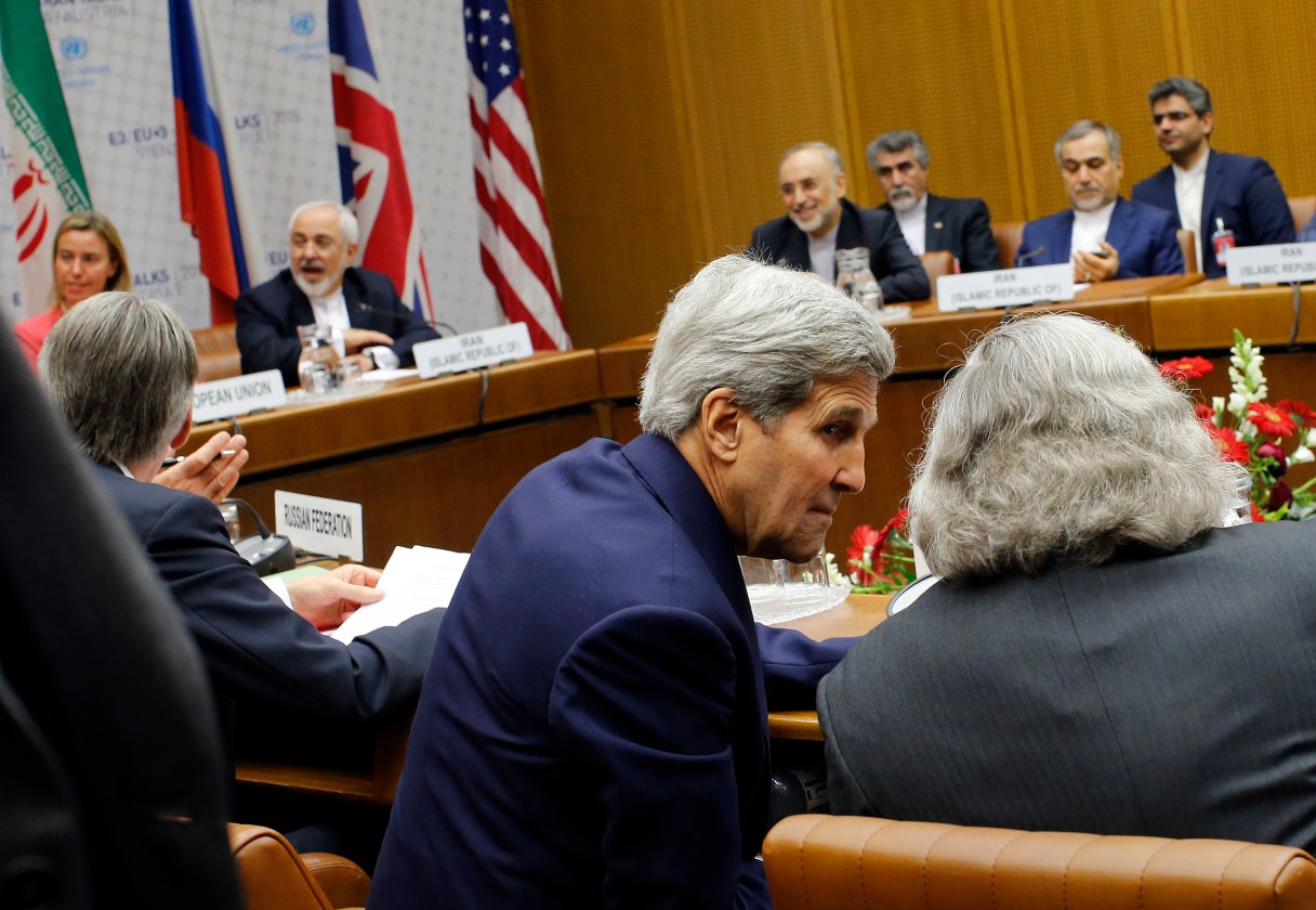 FILE - In this July 14, 2015 file pool photo, Secretary of State John Kerry, talks with Energy Secretary Ernest Moniz, as Iranian Foreign Minister Mohammad Javad Zarif background second left, sits next to European Union High Representative for Foreign Affairs and Security Policy Federica Mogherini, during a plenary session at the United Nations building in Vienna, Austria. A torturous 2 ½ year effort replete with false starts, backward steps and missed deadlines, world powers and Iran on Tuesday transformed those early overtures into an outcome far profounder and perhaps even riskier: A nuclear accord that may reshape the security topography of the Middle East for a generation to come. (Carlos Barria, Pool Photo via AP, File)