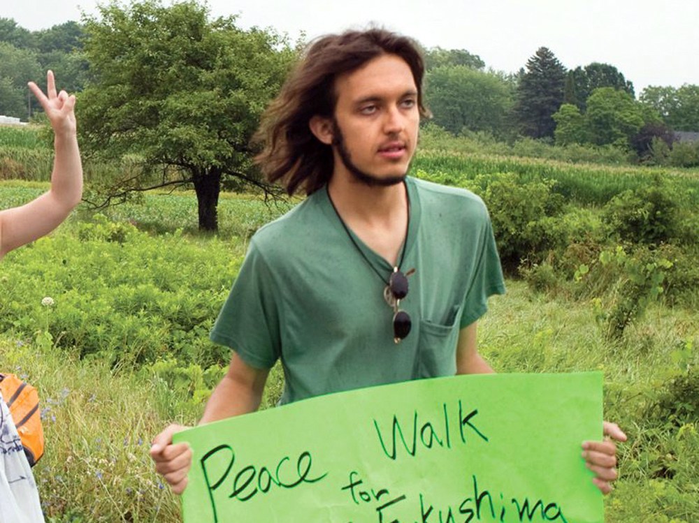 In this July 26, 2012 photo provided by the Northumberland News, Alexander Ciccolo participates in a peace walk through Brighton, Ontario. Law enforcement officials say Ciccolo was arrested after his father, a Boston police captain, alerted authorities that his son was talking about joining the Islamic State group and setting off bombs. (Dave Fraser/Northumberland News via AP) MANDATORY CREDIT