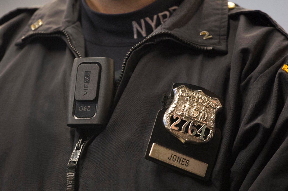 FILE - In this Dec. 3, 2014 file photo, New York Police Department officer Joshua Jones wears a VieVu body camera on his chest during a news conference in New York. A body camera pilot program at the nation's largest police department raised a wide range of questions about how to best monitor police and community interactions, according to a report released Thursday, July 30, 2015. (AP Photo/Mark Lennihan, File)
