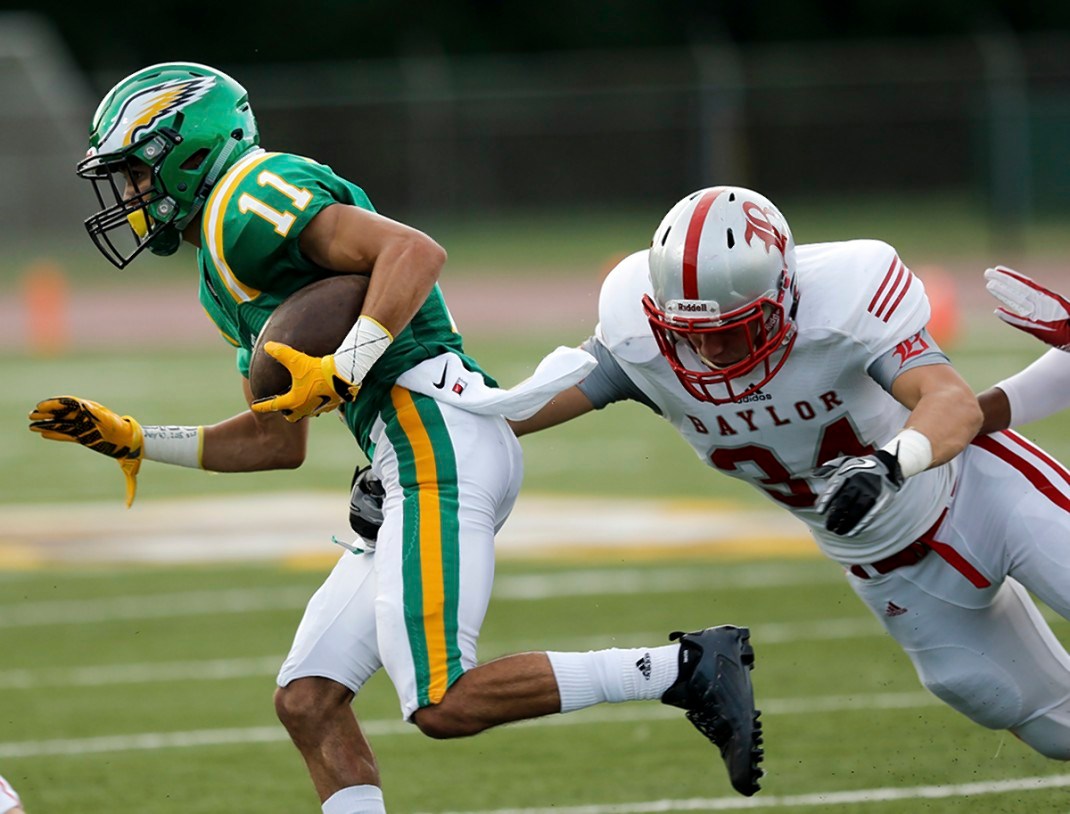 Rhea County's Noel Patterson slips past Baylor's Charlie Glascock during the season opener for both teams Thursday night at Rhea County High School. Few Chattanooga-area schools have been willing to play Baylor or McCallie since the TSSAA's 1997 public-private split.
