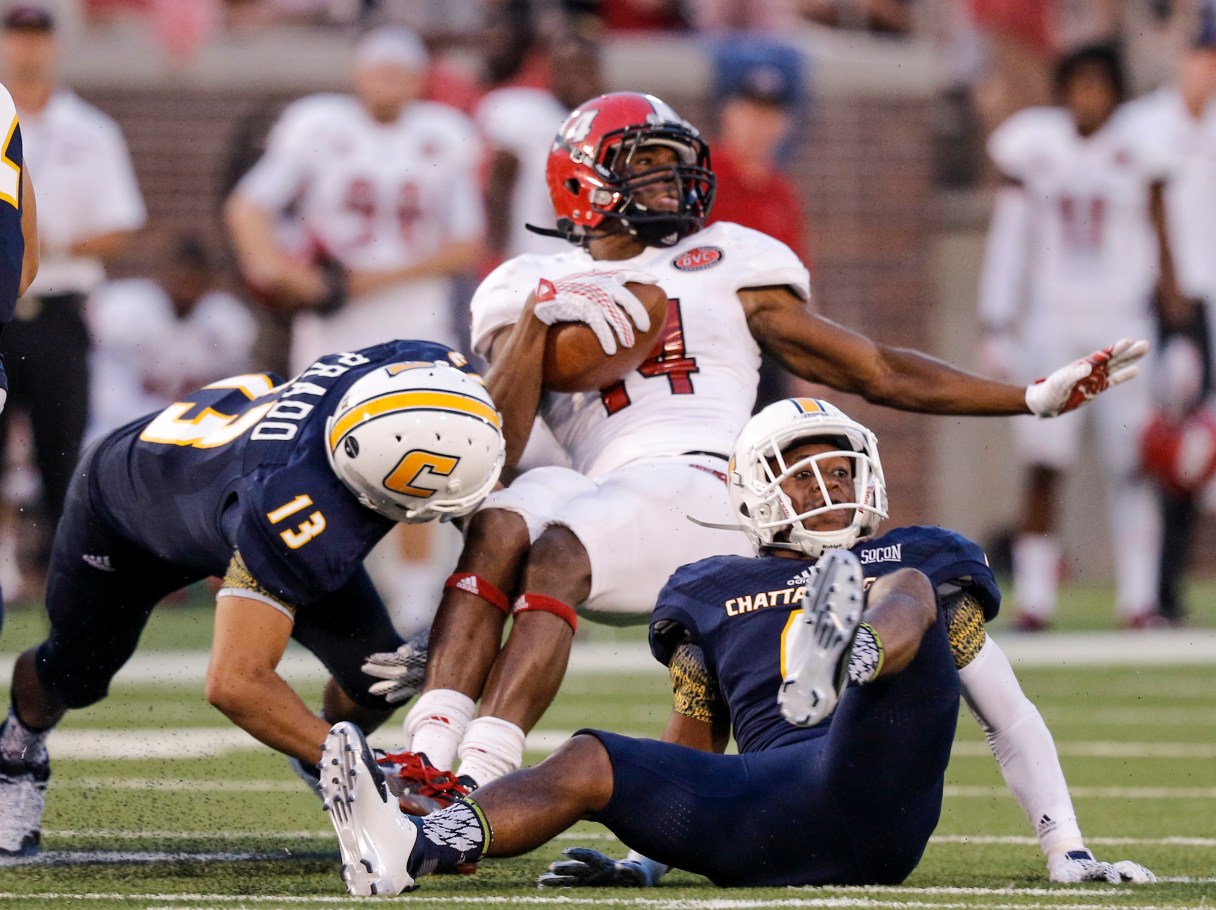 UTC defensive backs Oscar Prado (13) and C.J. Fritz, right, tackle Jacksonville State running back Troymaine Pope during the Mocs' season-opener football game against Jacksonville State at Finley Stadium on Saturday, Sept. 5, 2015, in Chattanooga, Tenn.