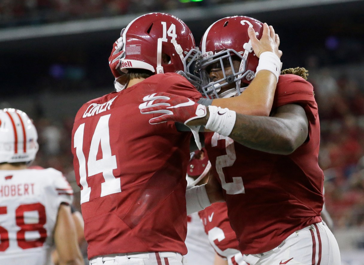 FILE - In this Sept. 4, 2015, file photo, Alabama running back Derrick Henry (2) celebrates rushing for a touchdown with quarterback Jake Coker (14) during the second half of an NCAA college football game against Wisconsin in Arlington, Texas. (AP Photo/LM Otero, File)
