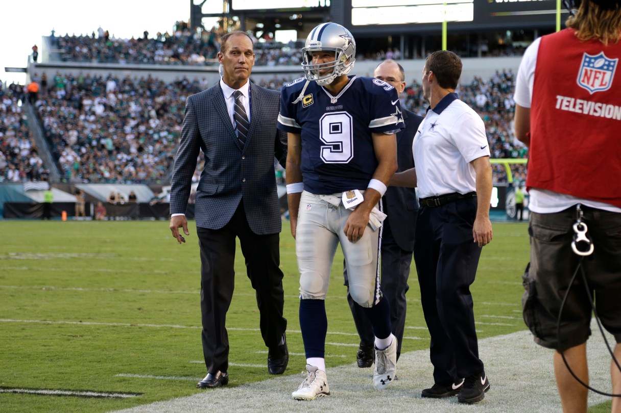 Dallas Cowboys' Tony Romo is helped off the field after an injury during the second half of an NFL football game against the Philadelphia Eagles, Sunday, Sept. 20, 2015, in Philadelphia. (AP Photo/Matt Rourke)