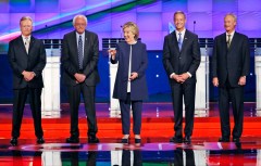 Former Secretary of State Hillary Clinton, center, can afford to be all smiles since, in spite of the four men flanking her, she has no competition for the 2016 Democratic presidential nomination.
