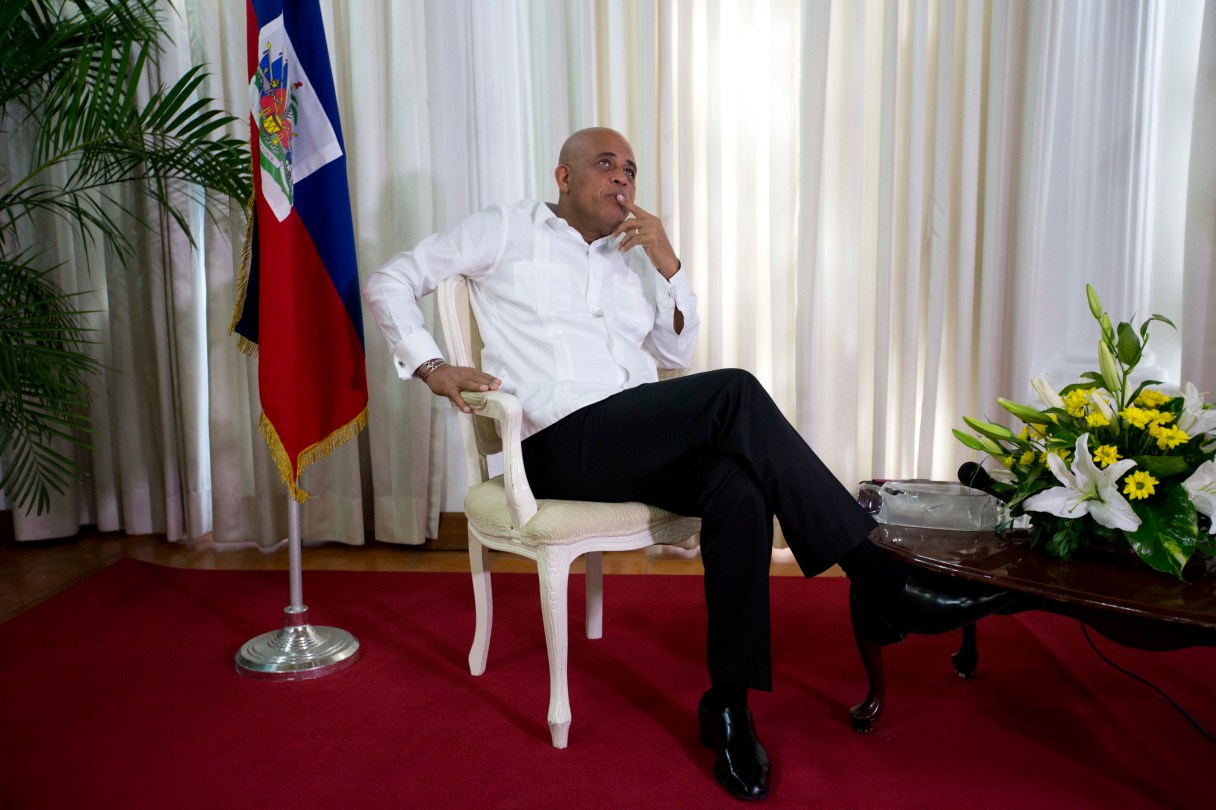 Haiti's President Michel Martelly gestures during an interview at the National Palace in Port-au-Prince, Haiti, Monday, Dec. 21, 2015. Martelly defended Haiti’s elections and asserted that an October presidential round that put the government-backed candidate on top was a genuine reflection of the people’s will. (AP Photo/Dieu Nalio Chery)