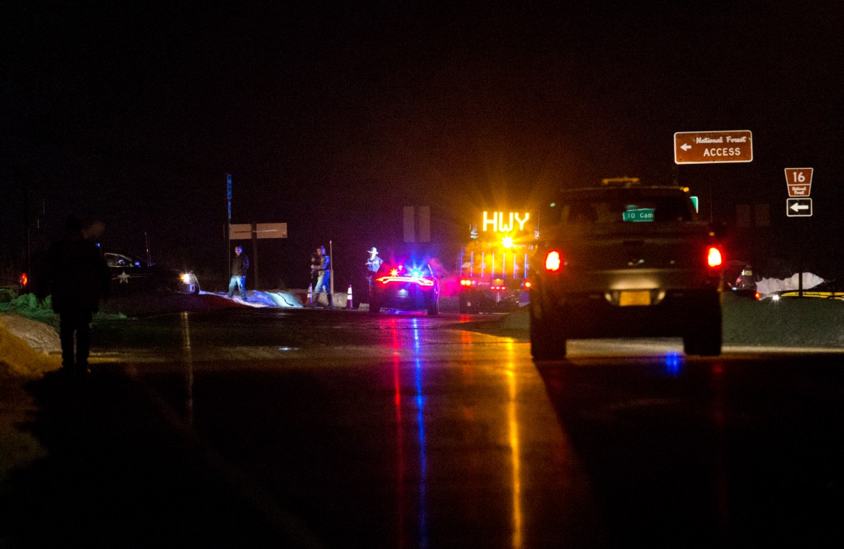 Highway 395 is blocked at Seneca between John Day and Burns, Ore., by Oregon State police officers the evening of Tuesday, Jan. 26, 2016. A more than 50-mile stretch of highway in Oregon has been closed near where an armed group has been occupying a national wildlife refuge. A group led by Ammon Bundy seized the headquarters of the Malheur National Wildlife Refuge south of Burns on Jan. 2 as part of a long-running dispute over public lands in the West. (Dave Killen/The Oregonian via AP) MAGS OUT; TV OUT; NO LOCAL INTERNET; THE MERCURY OUT; WILLAMETTE WEEK OUT; PAMPLIN MEDIA GROUP OUT; MANDATORY CREDIT