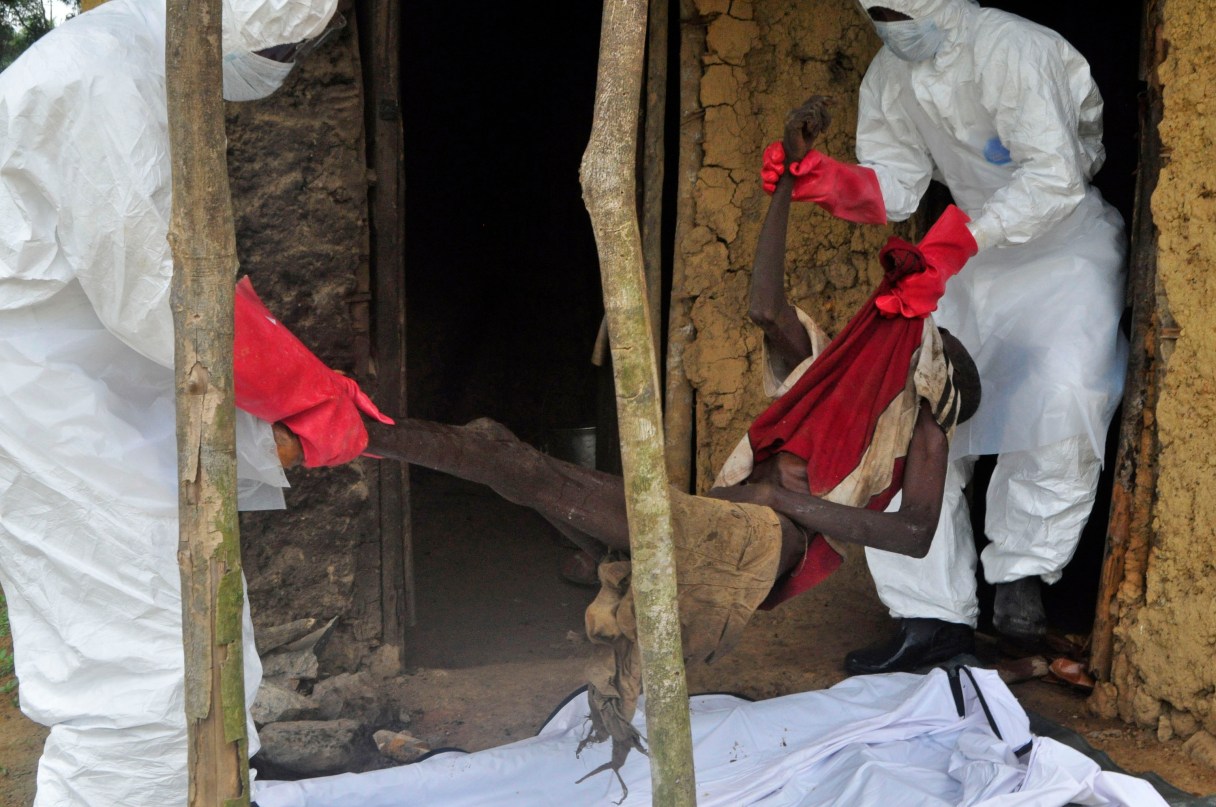 FILE- This is a Friday, Oct. 31, 2014 file photo of hearth workers as they carry the body of an old man from his house as he is suspected of dying from the Ebola virus in the Siah Town area on the outskirts of Monrovia, Liberia. The World Health Organization on Thursday Jan. 14, 2016 declared an end to the Ebola virus outbreak in West Africa after no new cases emerged in Liberia, while cautioning that the world cannot yet be fully declared free of the disease that claimed more than 11,300 lives during a two-year outbreak. (AP Photo/ Abbas Dulleh, File)
