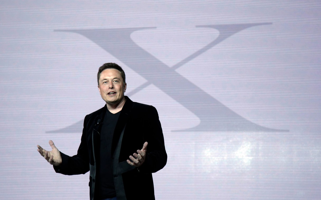 FILE - In a Tuesday, Sept. 29, 2015 file photo, Elon Musk, CEO of Tesla Motors Inc., introduces the Model X car at the company's headquarters, in Fremont, Calif. Some Tesla Motors vehicles can park themselves without a driver inside with a software update beamed to customers over the Jan. 9-10 weekend. Musk said the parking feature is a "baby step" toward his eventual goal: Letting drivers summon their self-driving, self-charging cars from anywhere using their phones. (AP Photo/Marcio Jose Sanchez, File)