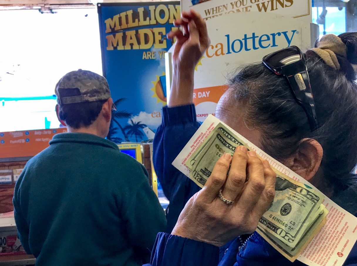 FILE - In this Jan. 13, 2016 file photo, customers wait to buy lottery tickets at the Blue Bird liguor store in Hawthorne, Calif. With hours to go and $63 million on the line, the mystery remains: Where’s the winning California Lottery ticket - the one sold last Aug. 8, that is - and why hasn’t somebody cashed it? Whatever the reason, it won’t be a good enough excuse if the 5 p.m. Thursday, Feb. 4, 2016 deadline passes and nobody produces the ticket at a lottery office. The ticket was sold at a 7-Eleven store in the Chatsworth neighborhood of Los Angeles.(AP Photo/Damian Dovarganes, File)