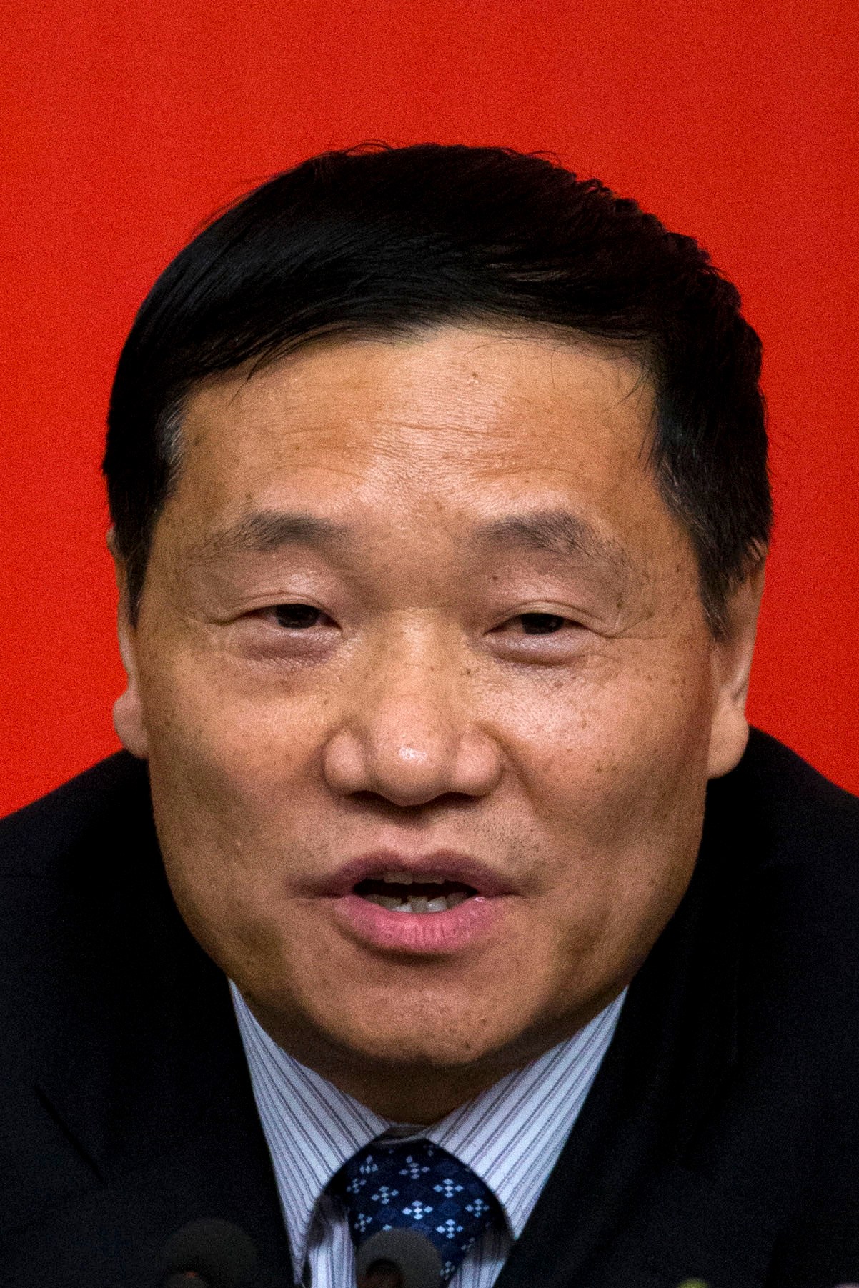 FILE - In this file photo taken Sunday, Nov. 11, 2012, Xiao Gang, then chairman and Communist Party chief of Bank of China, speaks during a press conference at the media center of the 18th Communist Party Congress in Beijing, China. Xiao who was appointed China's top securities regulator in March 2013 will step down following months of turmoil in the Chinese stock markets, the state-run news agency said Saturday, Feb 20, 2016.( AP Photo/Alexander F. Yuan, File)