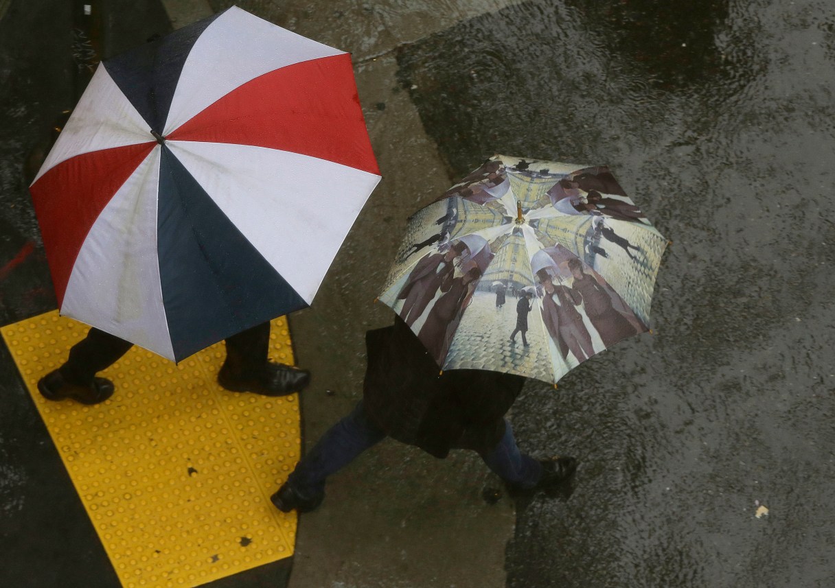 Pedestrian cross the street in San Francisco, Friday, March 4, 2016. The National Weather Service says California's withering winter dry spell will end this weekend as a series of storms move through the state. (AP Photo/Jeff Chiu)