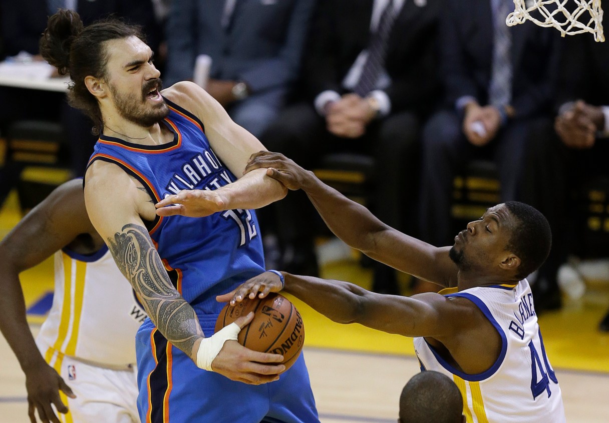 Oklahoma City Thunder center Steven Adams, left, is defended by Golden State Warriors forward Harrison Barnes during the first half of Game 7 of the NBA basketball Western Conference finals in Oakland, Calif., Monday, May 30, 2016. (AP Photo/Ben Margot)