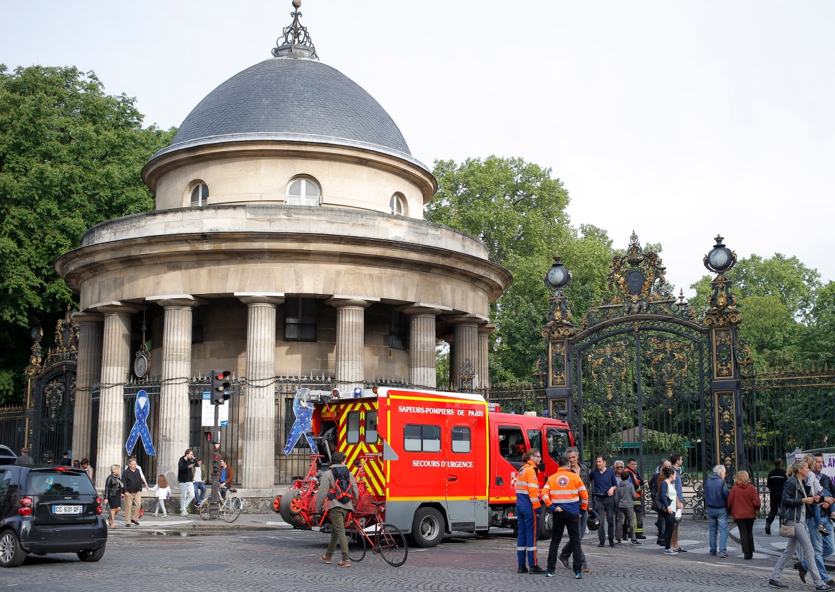 A fire truck is parked at the entrance to Monceau parc in the center of Paris, France, Saturday, May 28, 2016, after a lightning bolt crashed down onto a Paris park, striking 11 people at a child's birthday party. (AP Photo/Francois Mori)