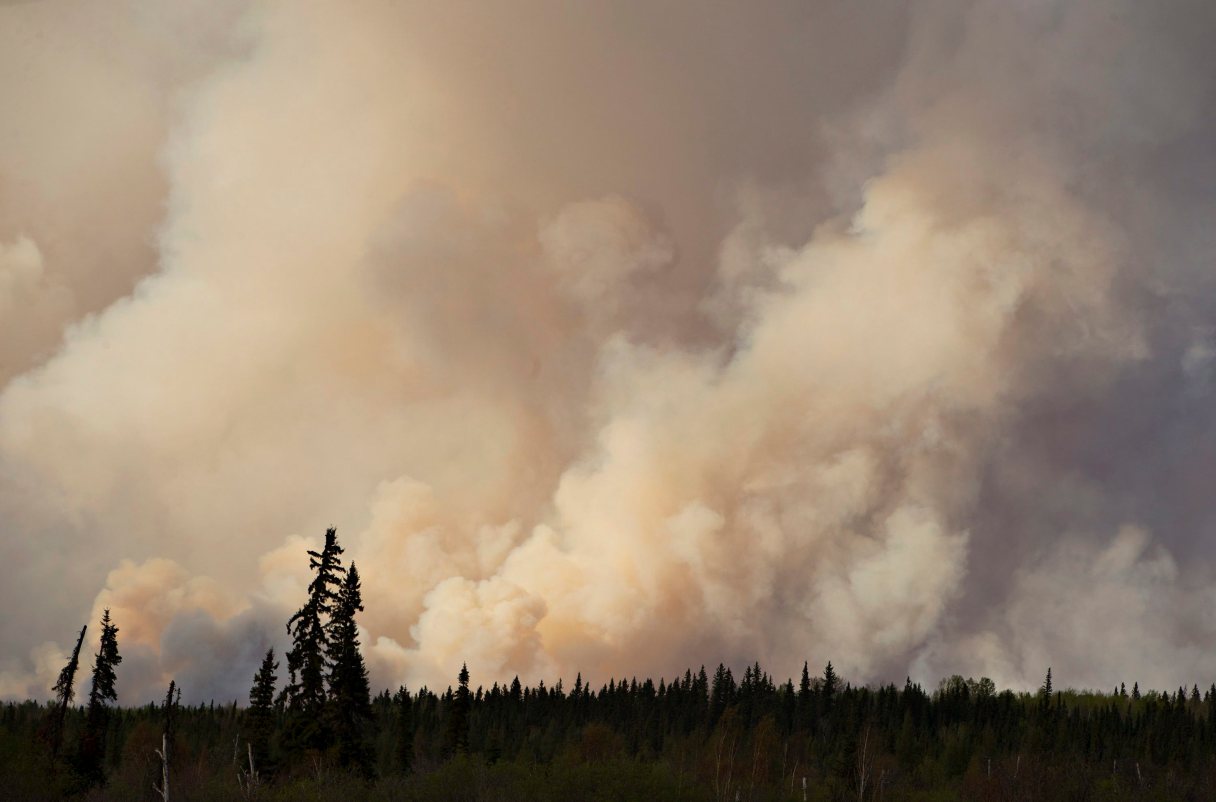 Smoke rises as a wildfire burns near Fort McMurray, Alberta, on Thursday, May 5, 2016. An ever-changing, volatile situation is fraying the nerves of residents and officials alike as a massive wildfire continues to bear down on the Fort McMurray area of northern Alberta. The province of Alberta declared a state of emergency. (Jason Franson/The Canadian Press via AP) MANDATORY CREDIT