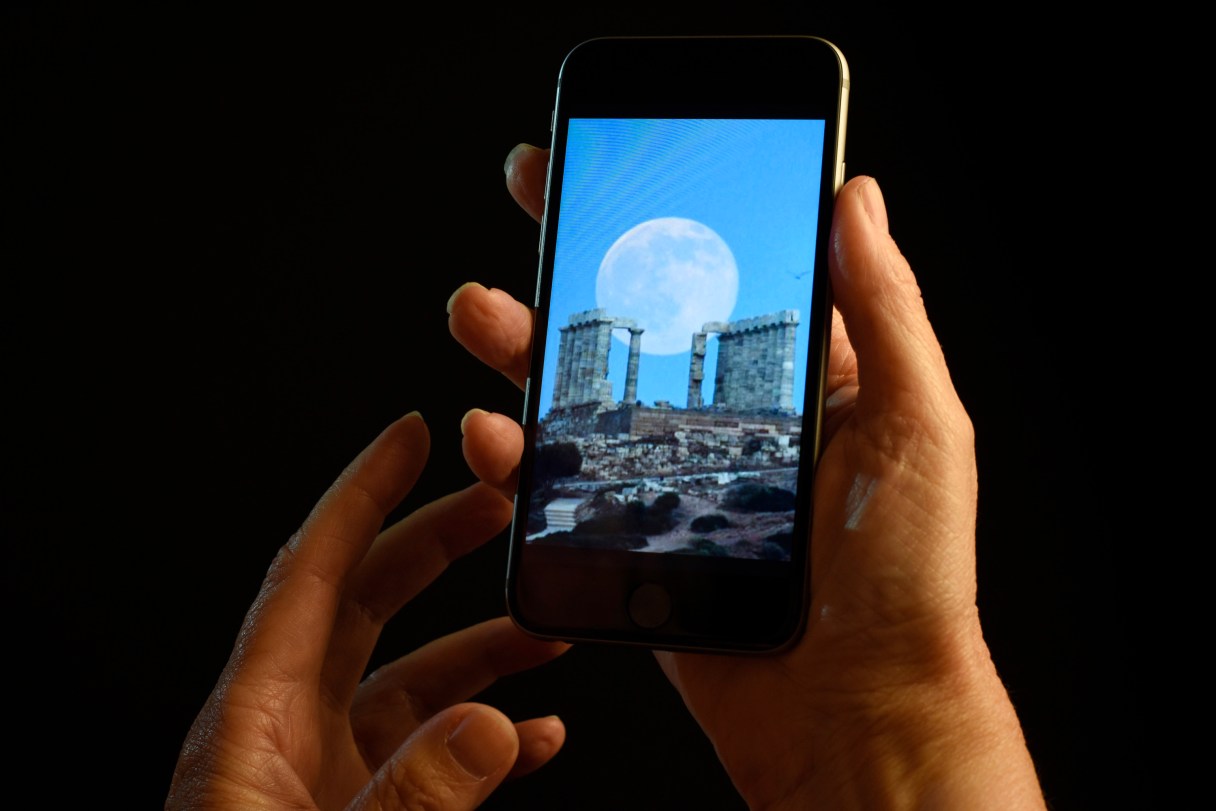 This July 21, 2016 photo shows a smartphone held for a photograph in New York. In a letter published Wednesday, July 22, 2016 in the New England Journal of Medicine, doctors detailed separate cases of two women who experienced "transient smartphone blindness" for months. Doctors discovered it was caused when they looked at their device with one eye while in bed in the dark _ and their other eye covered by a pillow. (AP Photo/Patrick Sison)