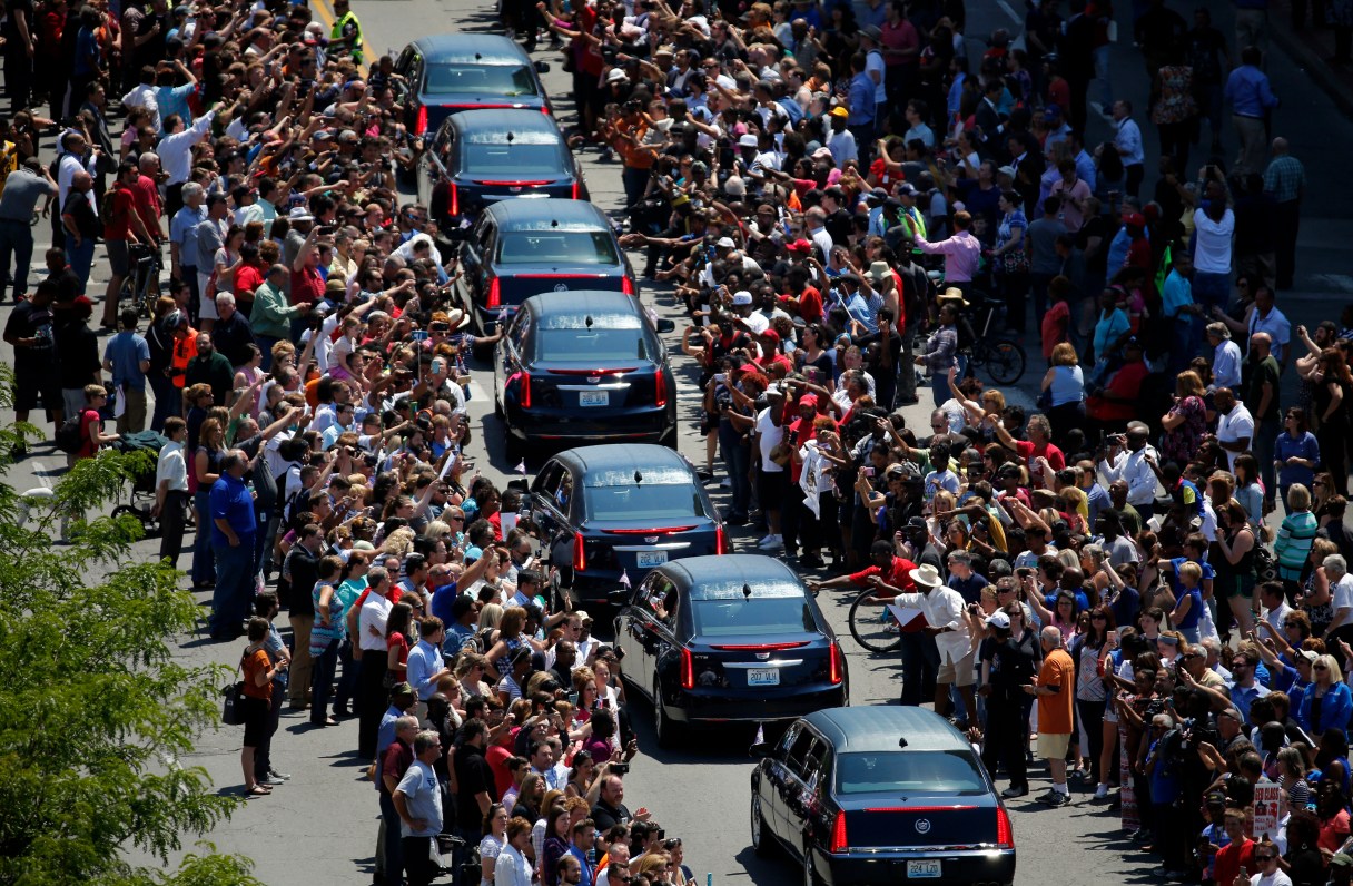 Muhammad Ali's funeral procession passes as onlookers line the street Friday, June 10, 2016, in Louisville, Ky. (AP Photo/Jeff Roberson)