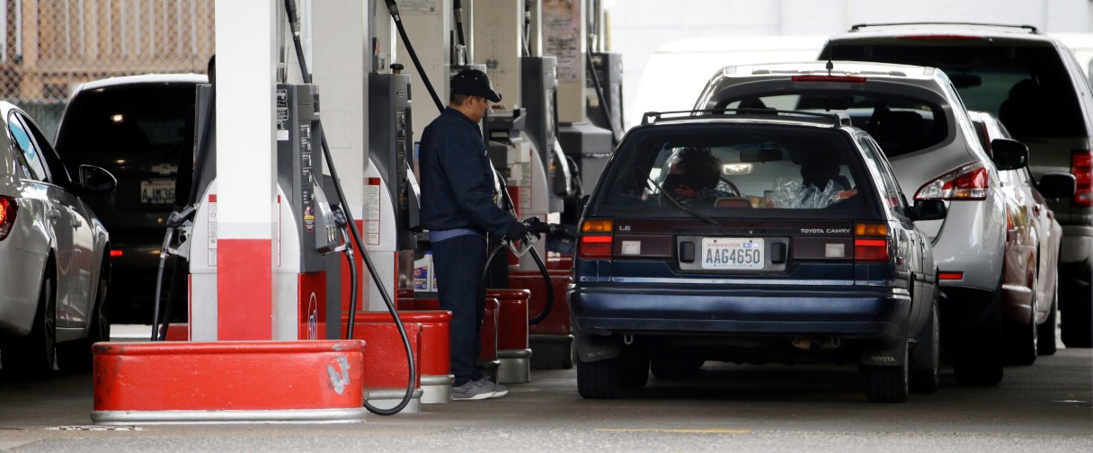 FILE - In this Wednesday, May 6, 2015, file photo, cars line up as an attendant pumps gas at a station in Portland, Ore. On Thursday, June 16, 2016, the Labor Department reports on U.S. consumer prices for April. (AP Photo/Don Ryan, File)