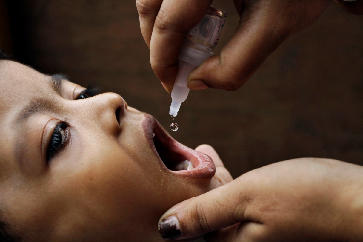 FILE- In this June 17, 2012, file photo, a health worker administers a polio drop to an infant in Kolkata, India. The southern Indian state of Telangana has declared a "high alert" for polio after an active strain of the virus was found in samples of sewage water in the state capital and about 350,000 children ranging from 6 weeks to 3 years old will be vaccinated in a weeklong campaign which will start on Monday, June 20, 2016. (AP Photo/Bikas Das, FILE)