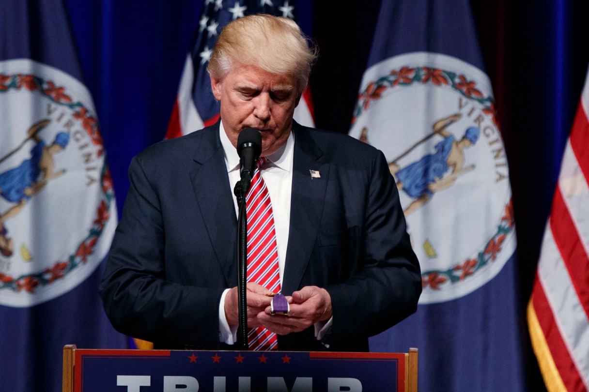 Republican presidential candidate Donald Trump holds a Purple Heart medal given to him by a supporter during a campaign rally at Briar Woods High School, Tuesday, Aug. 2, 2016, in Ashburn, Va. (AP Photo/Evan Vucci)