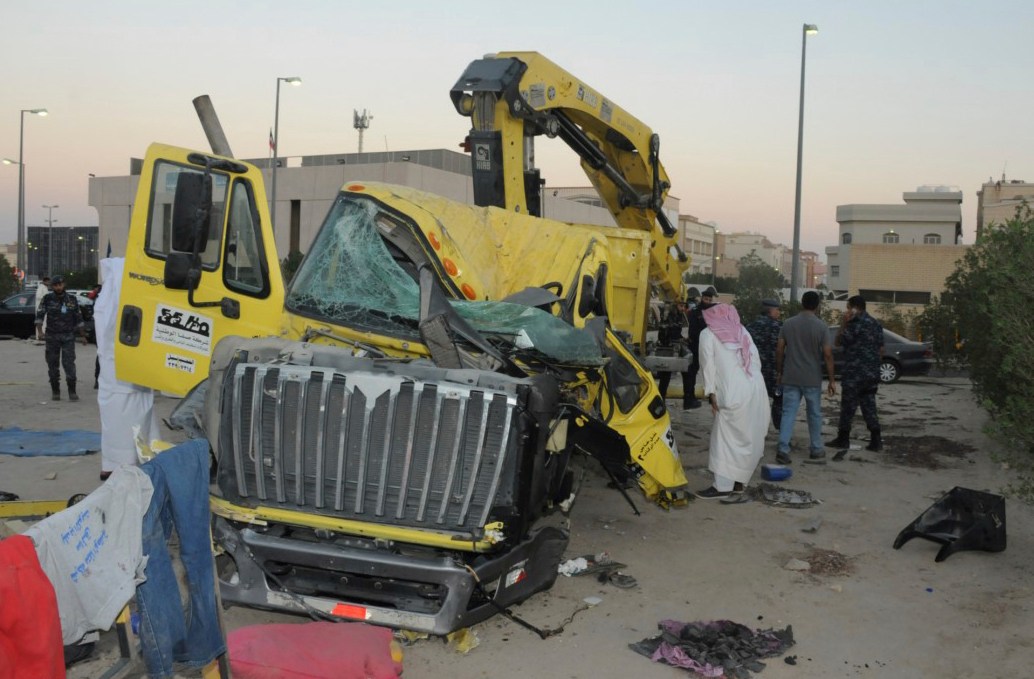 In this Saturday Oct. 8, 2016 photo released by Kuwait Ministry of Interiors, a damaged garbage truck after it rammed into another truck carrying five U.S. soldiers in Kuwait. An Egyptian driving a garbage truck loaded with explosives and Islamic State papers rammed into a truck carrying five U.S. soldiers in Kuwait on Saturday, injuring only himself in the attack, authorities said. (Kuwait Ministry of Interiors via AP)