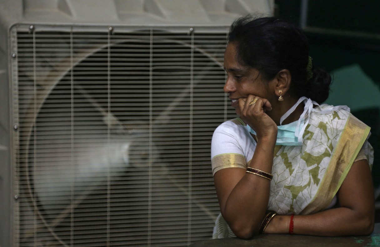 FILE - In this May 31, 2015 file photo, a woman cools herself on a hot summer day in Hyderabad, in the southern Indian state of Telangana. The U.N. weather agency said on Monday, Nov. 14, 2016, that 2016 is set to break the record for the hottest year since measurements began in the 19th century. (AP Photo/Mahesh Kumar A., File)