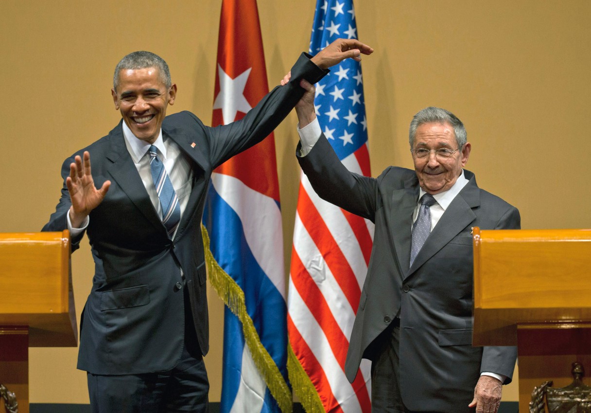 FILE - In this March 21, 2016 file photo, Cuban President Raul Castro, right, lifts up the arm of U.S. President Barack Obama, at the conclusion of their joint news conference at the Palace of the Revolution, in Havana, Cuba. Next year will likely be Castro’s toughest year in office since he took power in 2006, as the 85-year-old general faces a possible economic recession alongside a hostile new U.S. administration promising to undo measures that gave many Cubans expectations of a better future. (AP Photo/Ramon Espinosa, File)
