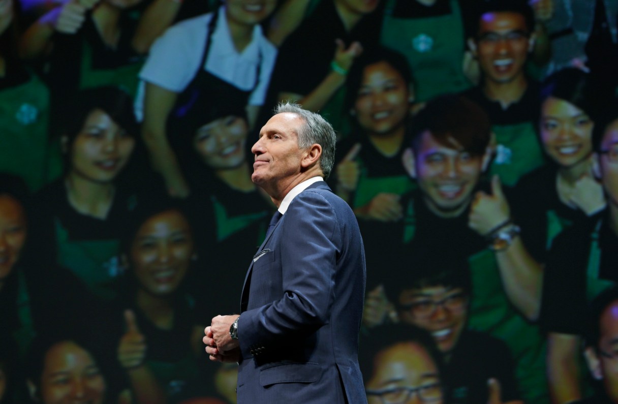 FILE - In this Wednesday, March 23, 2016, file photo, Starbucks CEO Howard Schultz walks in front of a photo of Starbucks baristas, at the coffee company's annual shareholders meeting in Seattle. Starbucks announced Thursday, Dec. 1, 2016, that Schultz is stepping down from the coffee chain that he joined more than 30 years ago, and that Kevin Johnson will become chief executive as of April 3, 2017. Schultz will become executive chairman on that date to focus on innovation and social impact activities, among other things.
(AP Photo/Ted S. Warren, File)