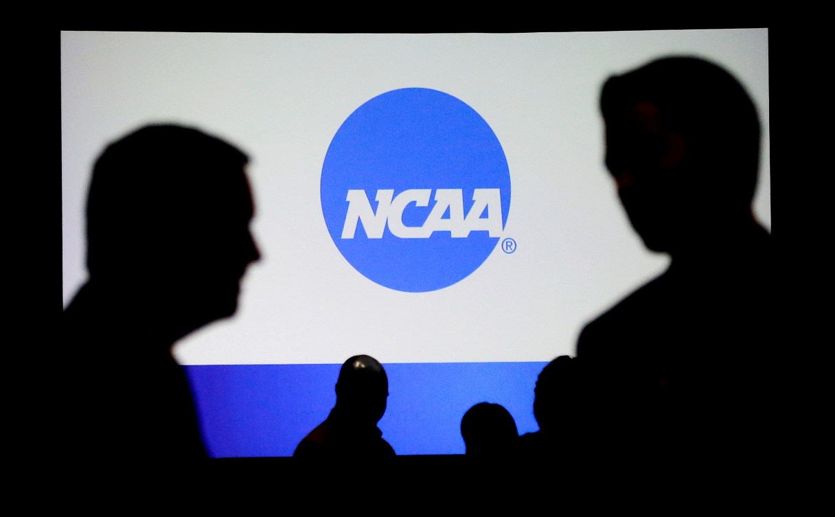 People talk after a panel discussion at the NCAA Convention Thursday, Jan. 19, 2017, in Nashville, Tenn. (AP Photo/Mark Humphrey)
