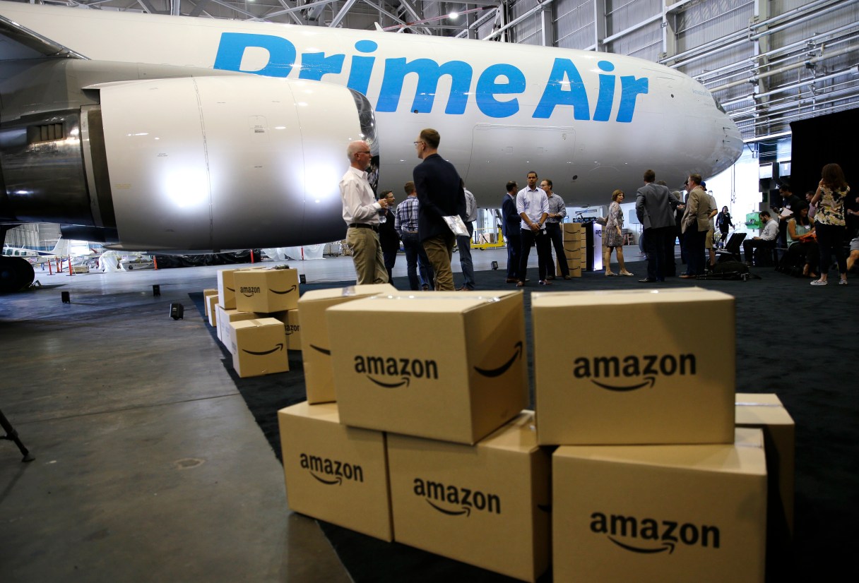 FILE - In this Thursday, Aug. 4, 2016, file photo, Amazon.com boxes are shown stacked near a Boeing 767 Amazon "Prime Air" cargo plane on display in a Boeing hangar in Seattle. Retail subscription programs, such as Amazon Prime, promise free shipping to members for a monthly or yearly fee. As shoppers demand speed, some cyberstores are offering free and fast shipping, albeit with minimum-purchase requirements. Certain situations, however, may warrant paying the membership fee. (AP Photo/Ted S. Warren, File)