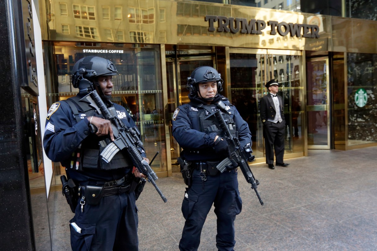 FILE - In this Nov. 11, 2016, file photo, New York City Police officers guard the front of Trump Tower, in New York. President Donald Trump is coming home. The born-and-bred New Yorker, whose image for decades was interwoven with his brash hometown, is making his first trip back to Manhattan since taking office, returning to New York City on Thursday, May 4, to mark the anniversary of an important World War II battle by making a speech on a decommissioned aircraft carrier docked on the Hudson River. (AP Photo/Richard Drew, File)