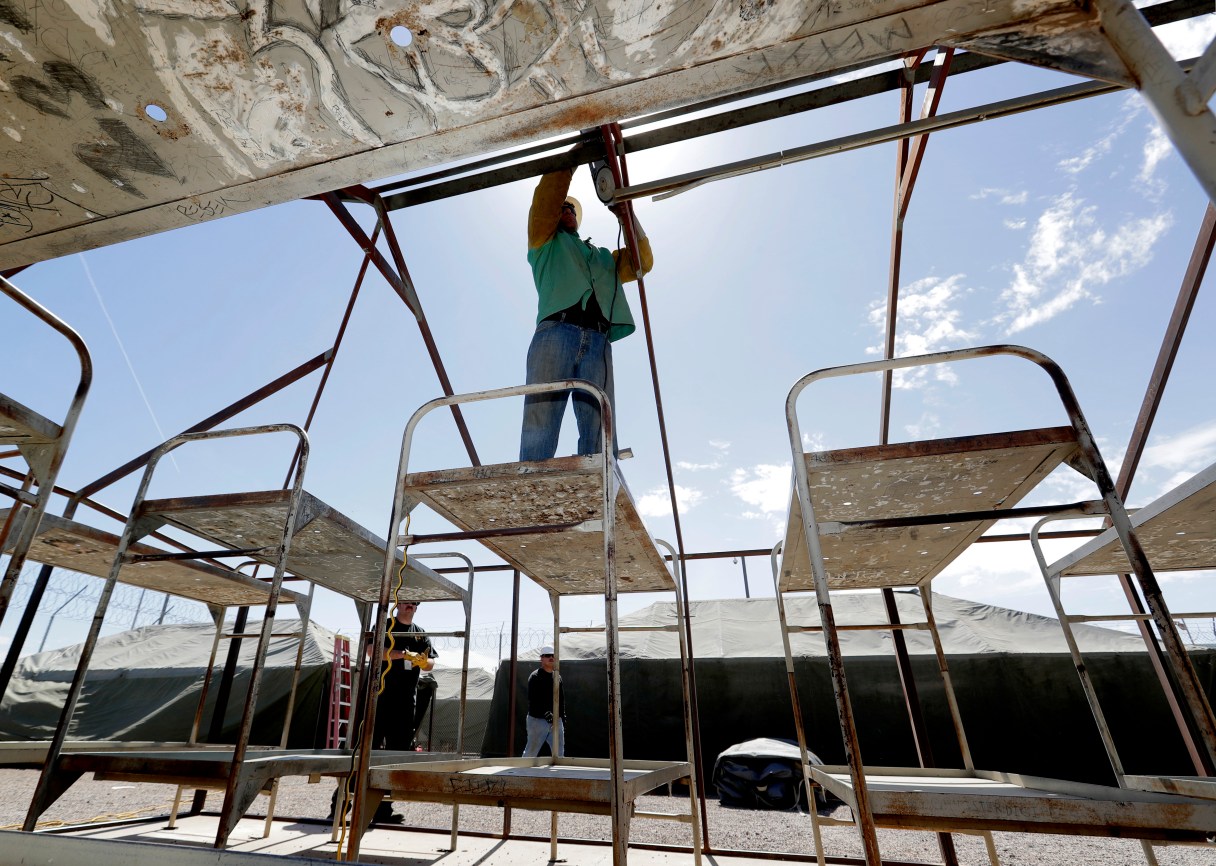 Maricopa County Sheriff personnel break down a tent in the Tent City Jail, Wednesday, May 24, 2017, in Phoenix. Crews have started to dismantle some of the tents in the controversial outdoor jail complex in Phoenix that's in the process of being closed by the metro area's new sheriff. (AP Photo/Matt York)