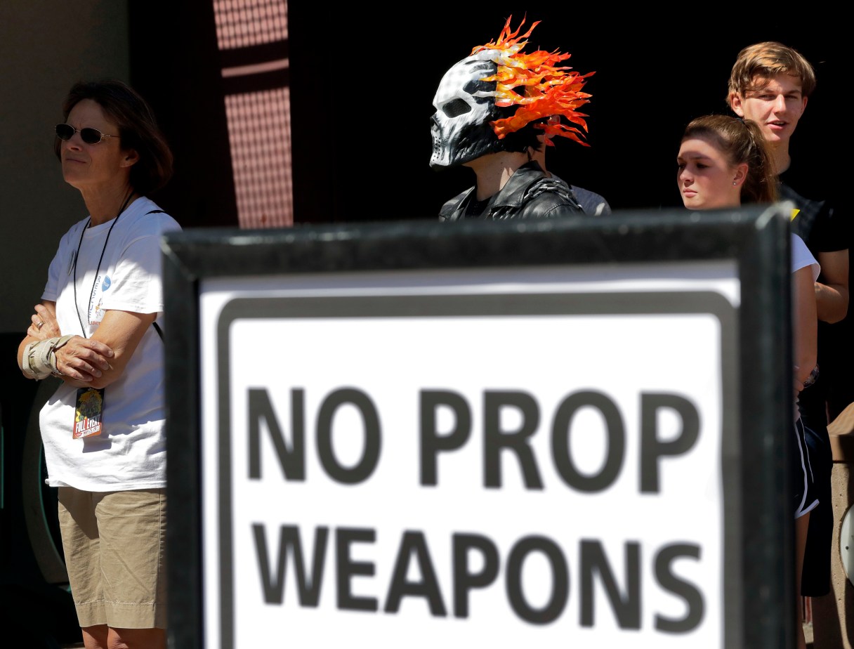 Fans line up to enter Comicon at the Phoenix Convention Center, Friday, May 26, 2017, in Phoenix. Comic book and science fiction fans showing up at the Phoenix Comicon festival will have all prop weapons - including swords, sabers and fake guns - confiscated after a man showed up at the event with real guns and caused a security scare. (AP Photo/Matt York)