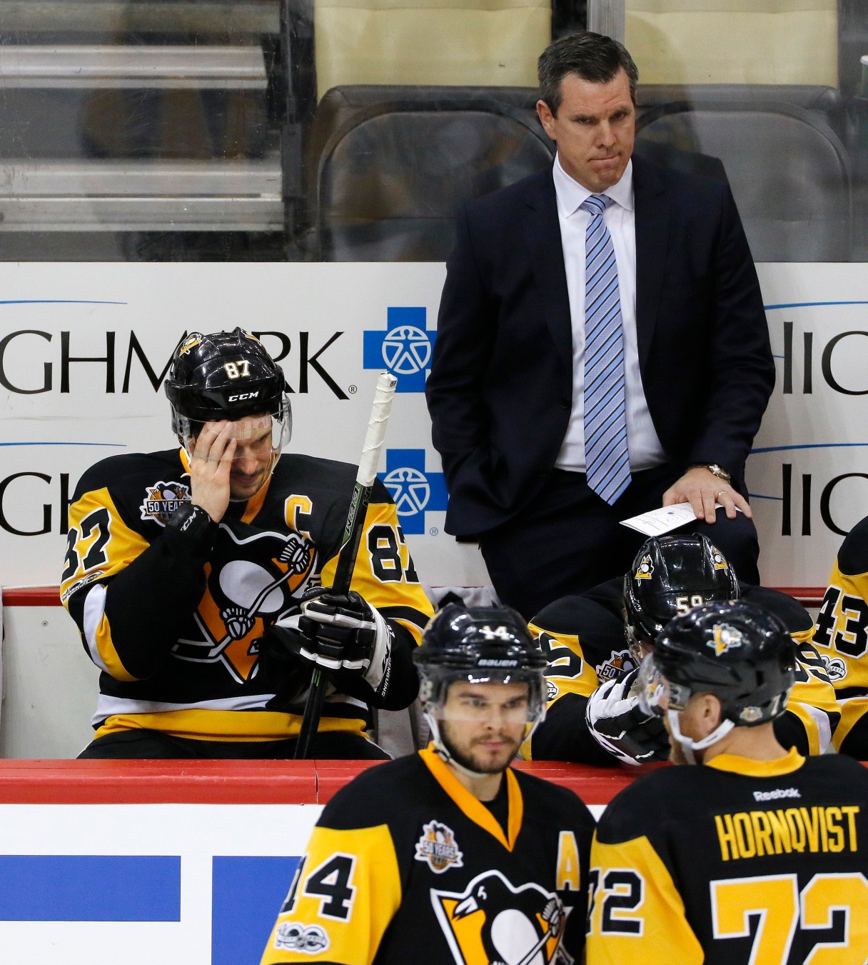 Pittsburgh Penguins' Sidney Crosby (87) sits on the bench with head coach Mike Sullivan behind him during the third period of Game 6 in an NHL Stanley Cup Eastern Conference semifinal hockey game against the Washington Capitals in Pittsburgh, Monday, May 8, 2017. The Capitals won 5-2 to force a Game 7. (AP Photo/Gene J. Puskar)